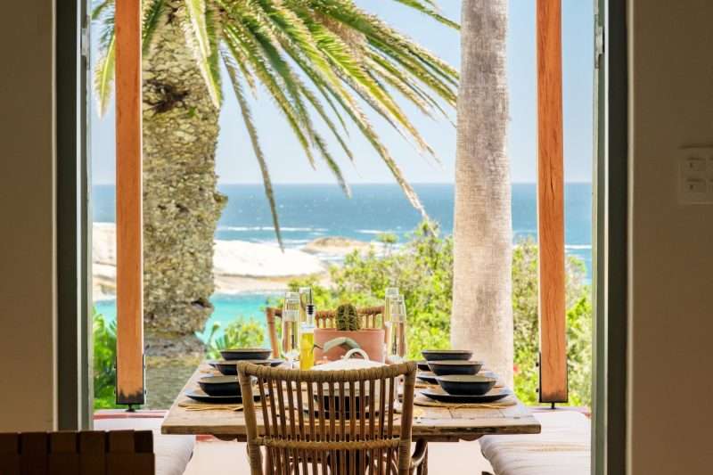 Alfresco dining setup overlooking the Atlantic Ocean at Villa Galazzio, Camps Bay