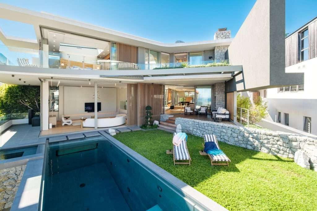 Modern luxury villa with private pool, garden, sun loungers, and open-plan living areas at Villa Serena in Cape Town.