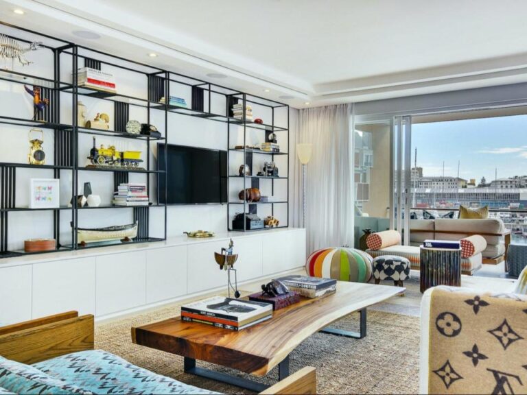 Stylish living area with custom shelving and marina-view balcony at Juliette 213