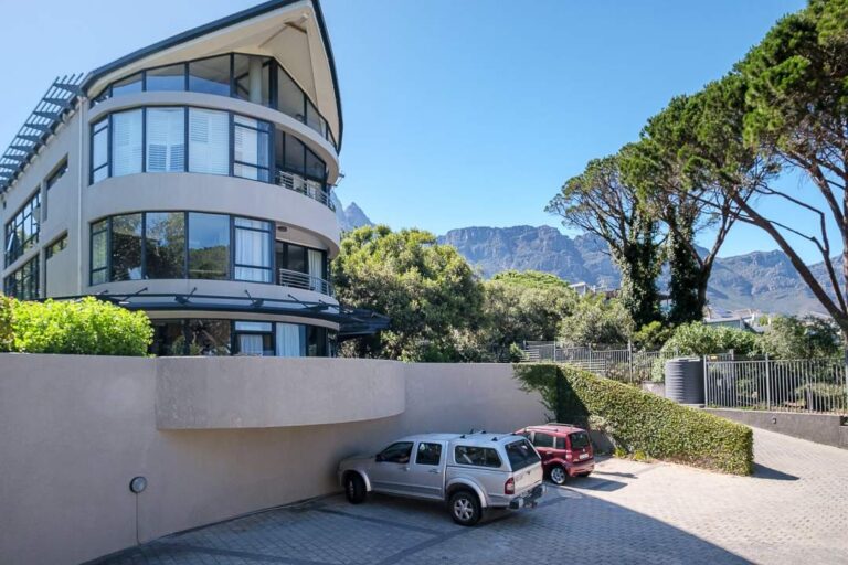 Exterior view of Vadi Apartment with mountain backdrop and private parking