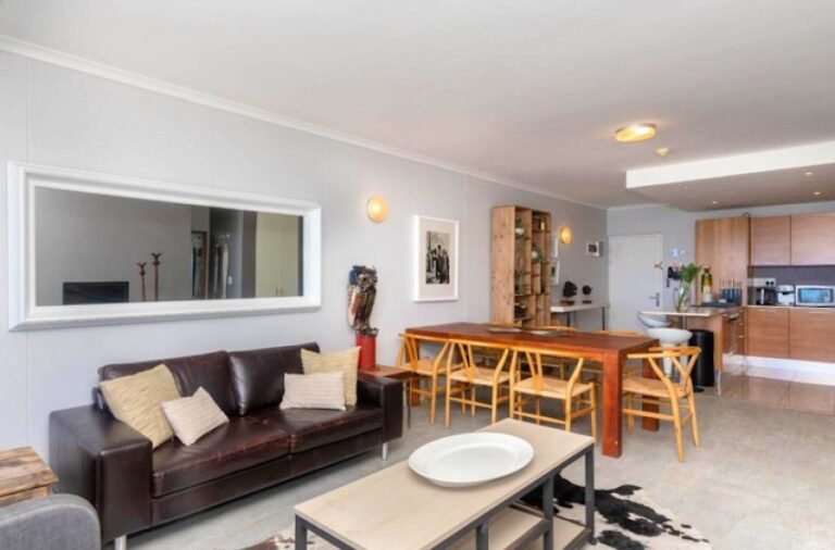 Chic living and dining space with contemporary coastal style at Horizon Bay 801