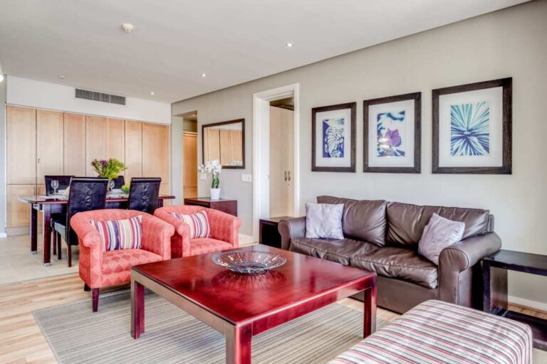 Elegant open-plan lounge and dining area with modern decor at Altmore 203