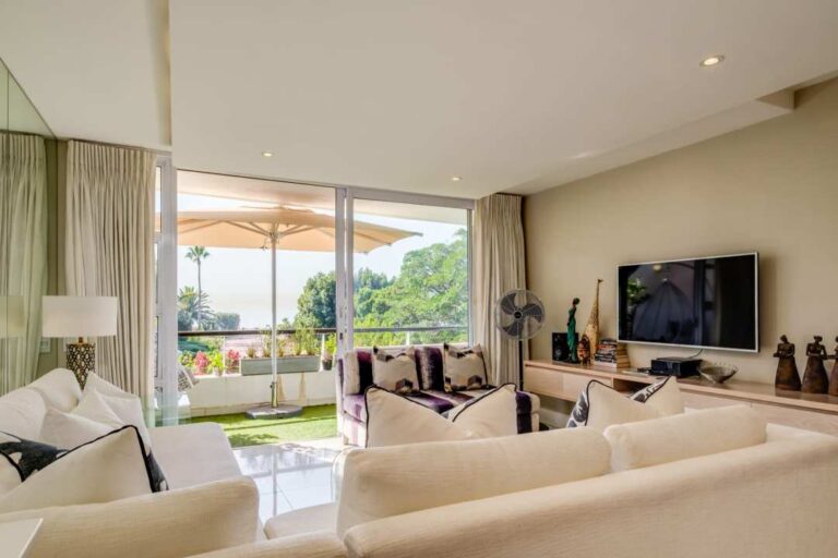 Elegant lounge with terrace and lush garden views at Amani Views