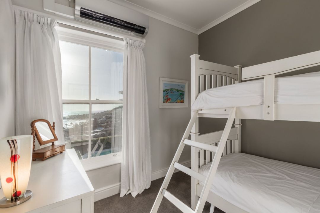 Cozy kids bedroom with bunk beds ocean view and neutral decor Villa Galazzio