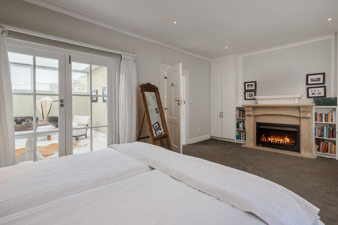 Spacious bedroom with fireplace private lounge access and cozy neutral decor Villa Galazzio