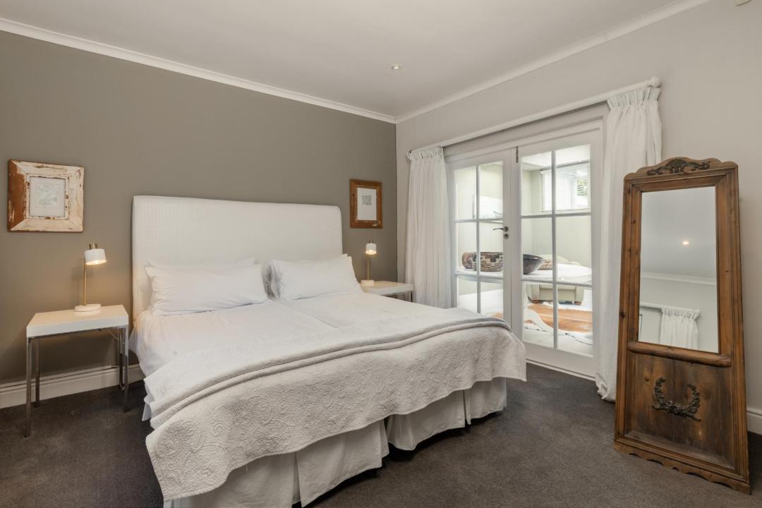 Elegant neutral bedroom with white bedding and private balcony access Villa Galazzio