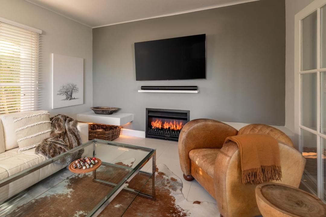 Elegant living room with fireplace leather armchair and modern decor Villa Galazzio