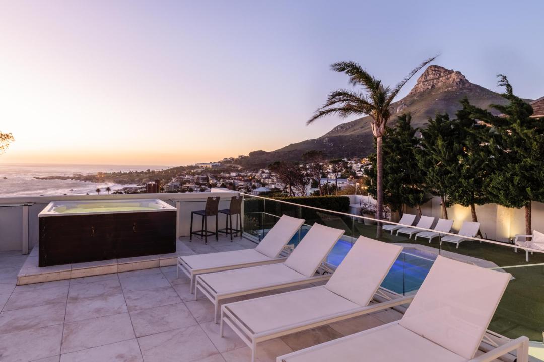 Rooftop terrace with loungers jacuzzi mountain and ocean views Villa Galazzio