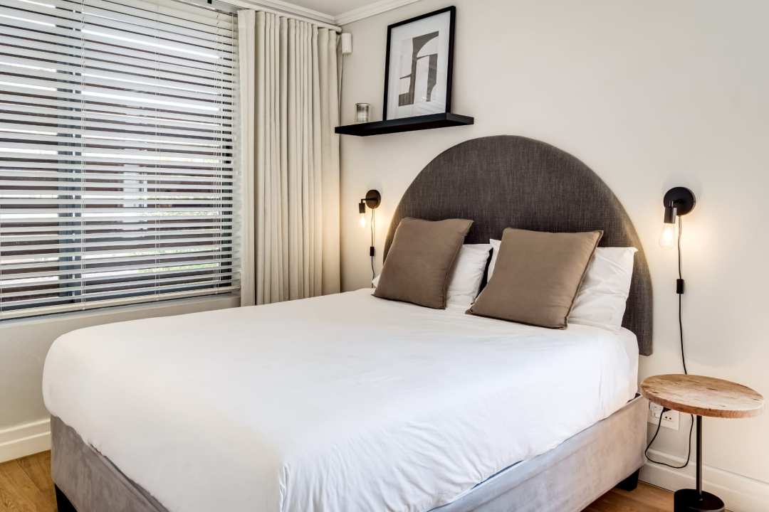 Contemporary bedroom with curved headboard and minimalist design at Aureto