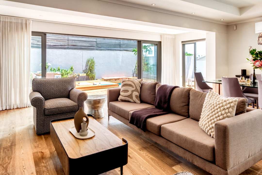 Inviting lounge with warm tones and poolside views at Aureto