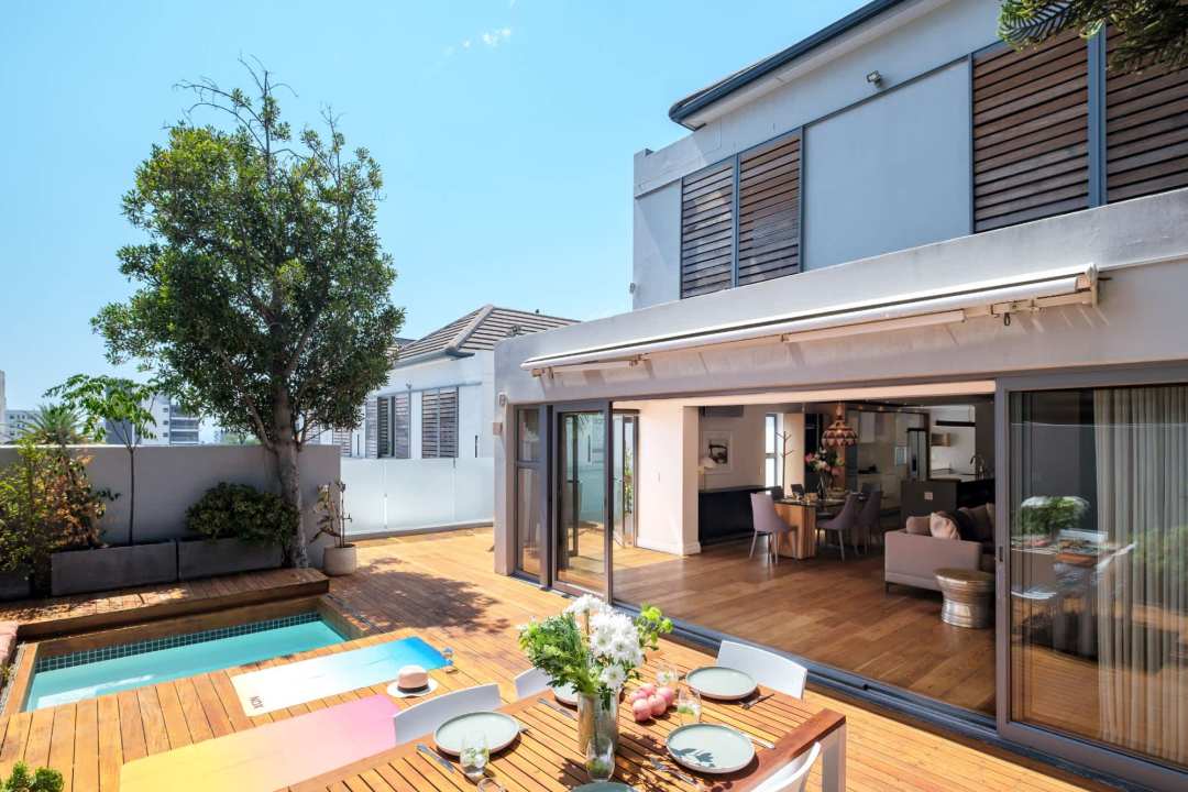 Sun-drenched deck with private pool and seamless indoor-outdoor flow at Aureto