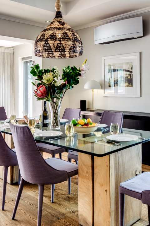 Stylish dining area with statement florals and elegant table setting at Aureto