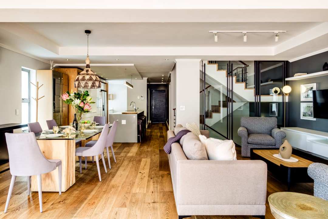 Elegant open-plan living and dining area with contemporary finishes at Aureto