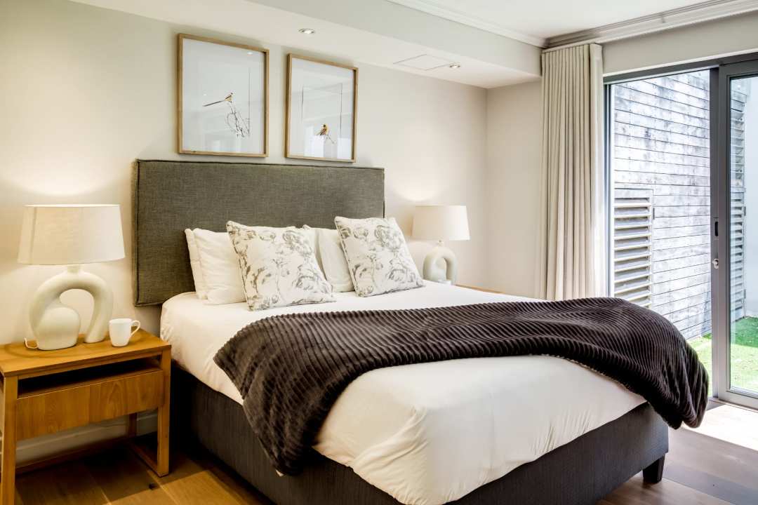 Inviting bedroom with garden views and soft neutral tones at Aureto
