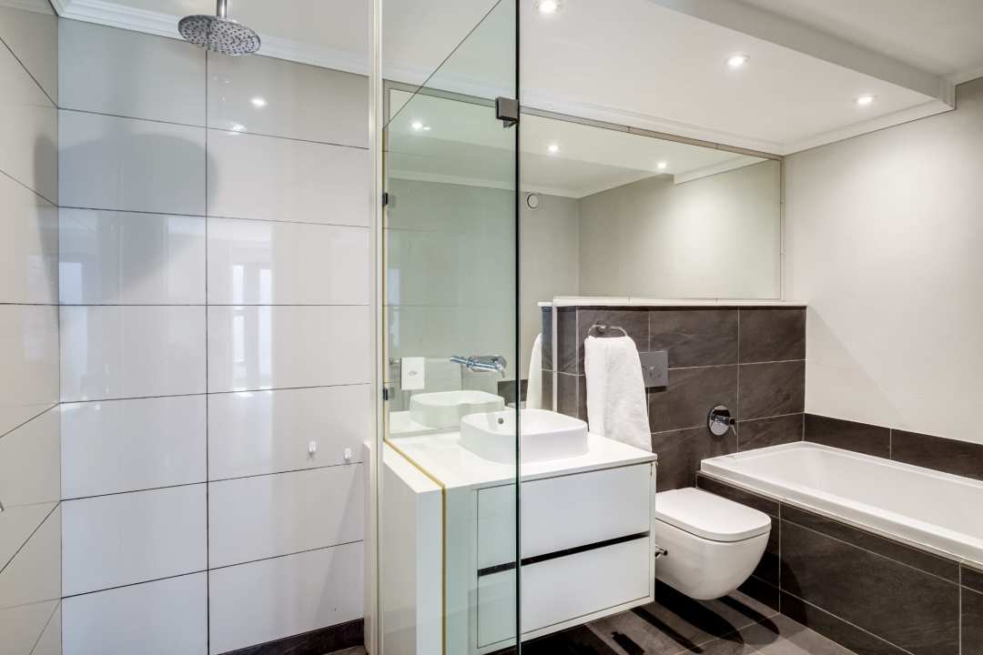 Modern bathroom with glass shower and monochrome palette at Aureto