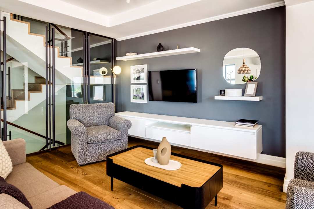 Contemporary lounge with sleek design and staircase views at Aureto