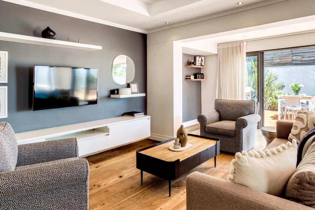 Stylish TV lounge with natural light and modern accents at Aureto