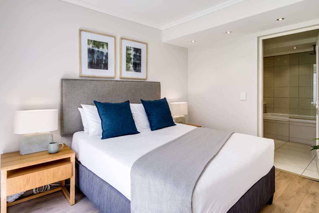 Serene bedroom with plush bedding and soft lighting at Aureto