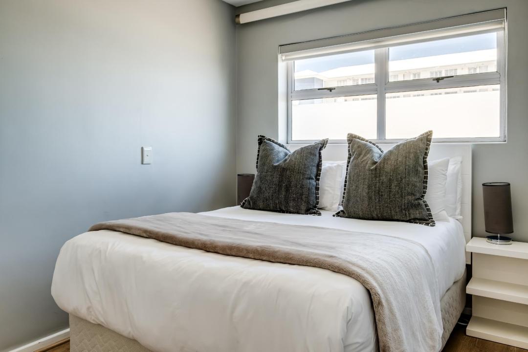 Cozy sunlit bedroom with neutral tones at Atlantic Views