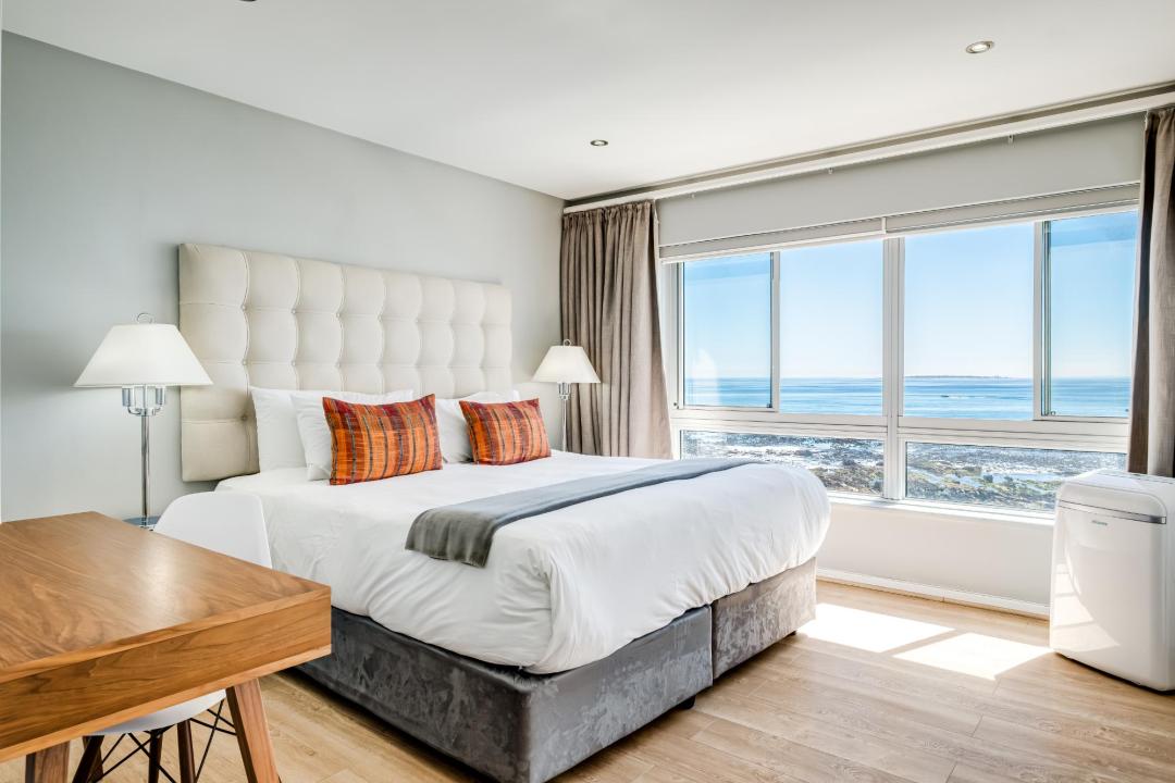 Sea-facing master bedroom with plush bedding and panoramic views at Atlantic Views
