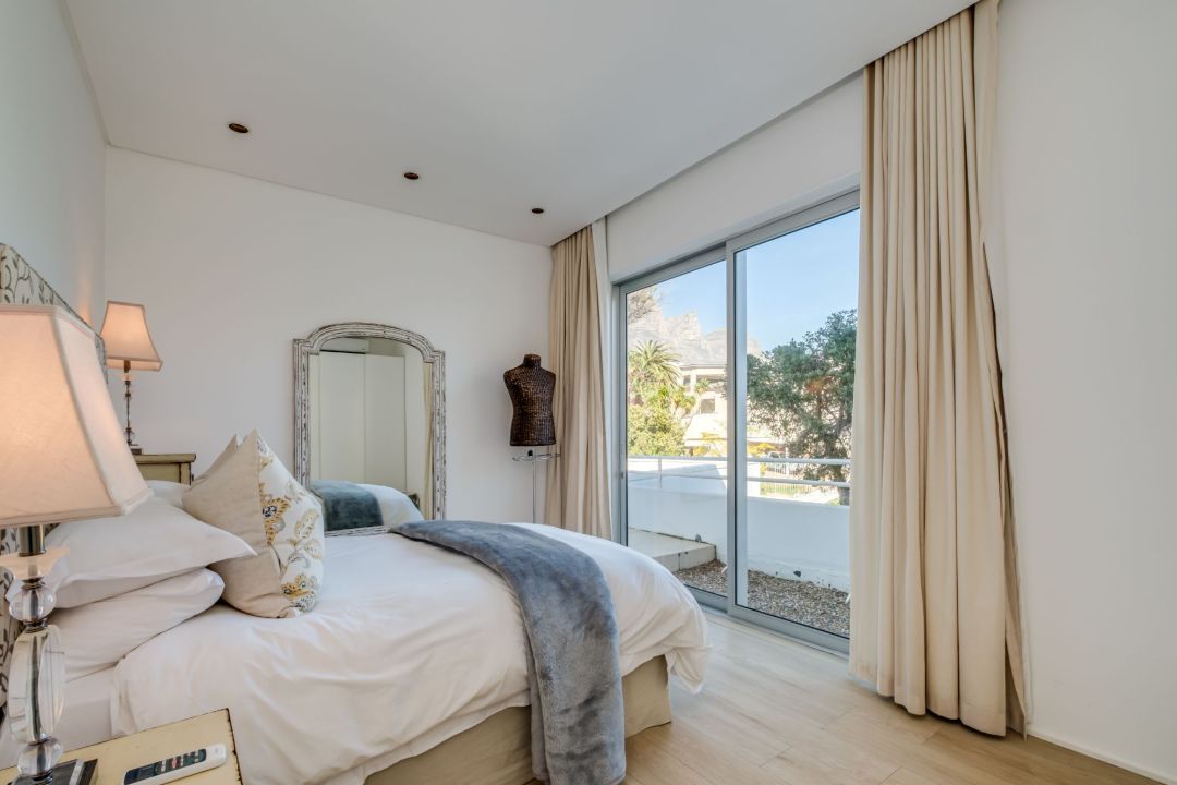 Chic bedroom with soft hues and sliding doors to a private terrace at Silvertree