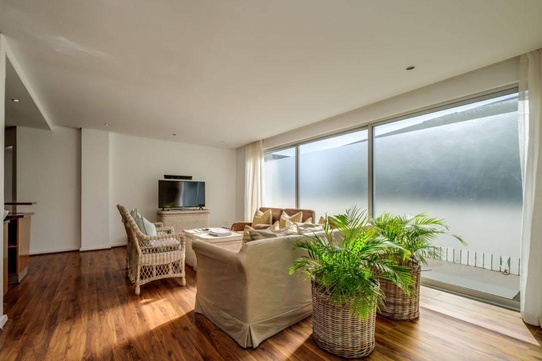 Tranquil lounge with natural light and indoor greenery at Silvertree