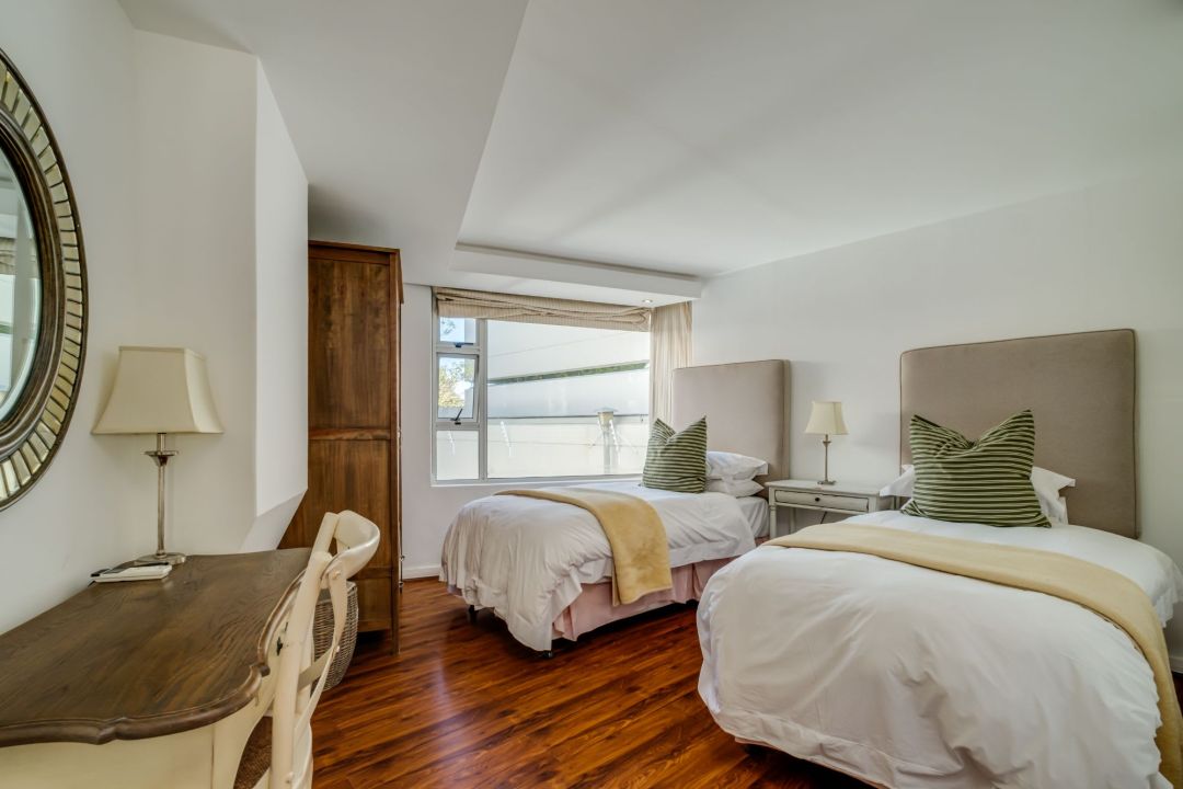 Charming twin bedroom with wooden accents and natural light at Silvertree