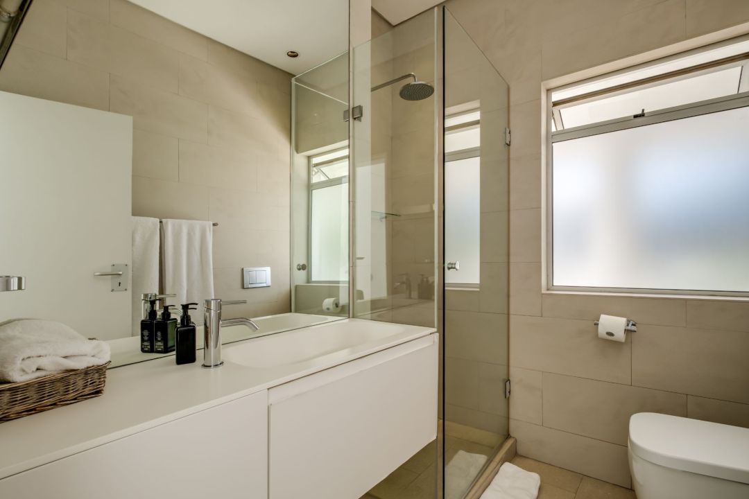 Minimalist bathroom with walk-in shower and soft natural light at Silvertree