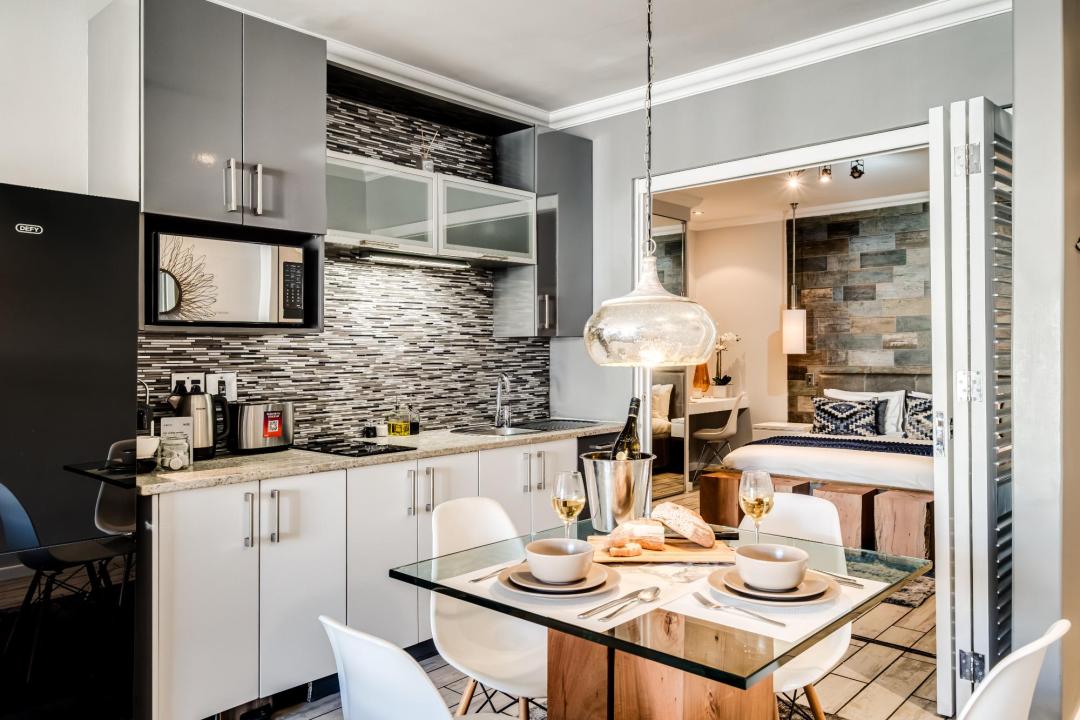 Open-plan kitchen and dining area with view into a designer bedroom at Stonewood