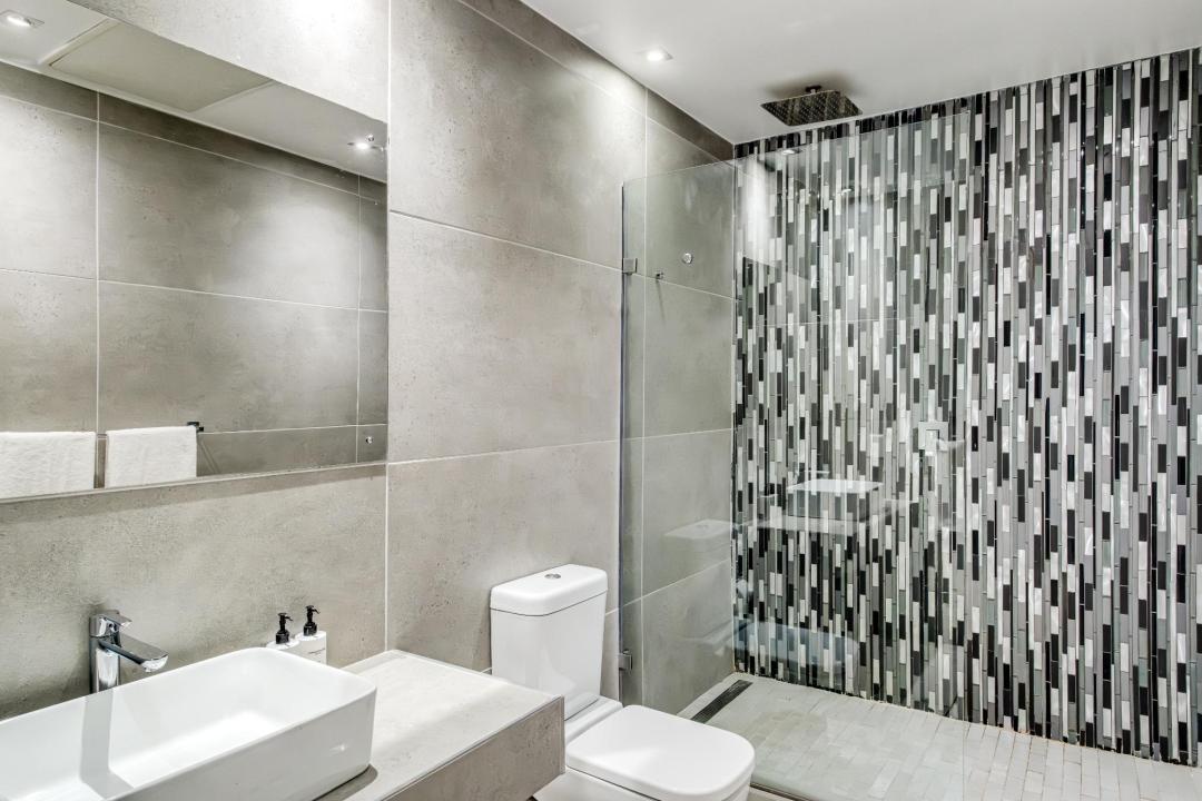 Contemporary bathroom with mosaic feature wall and walk-in shower at Stonewood