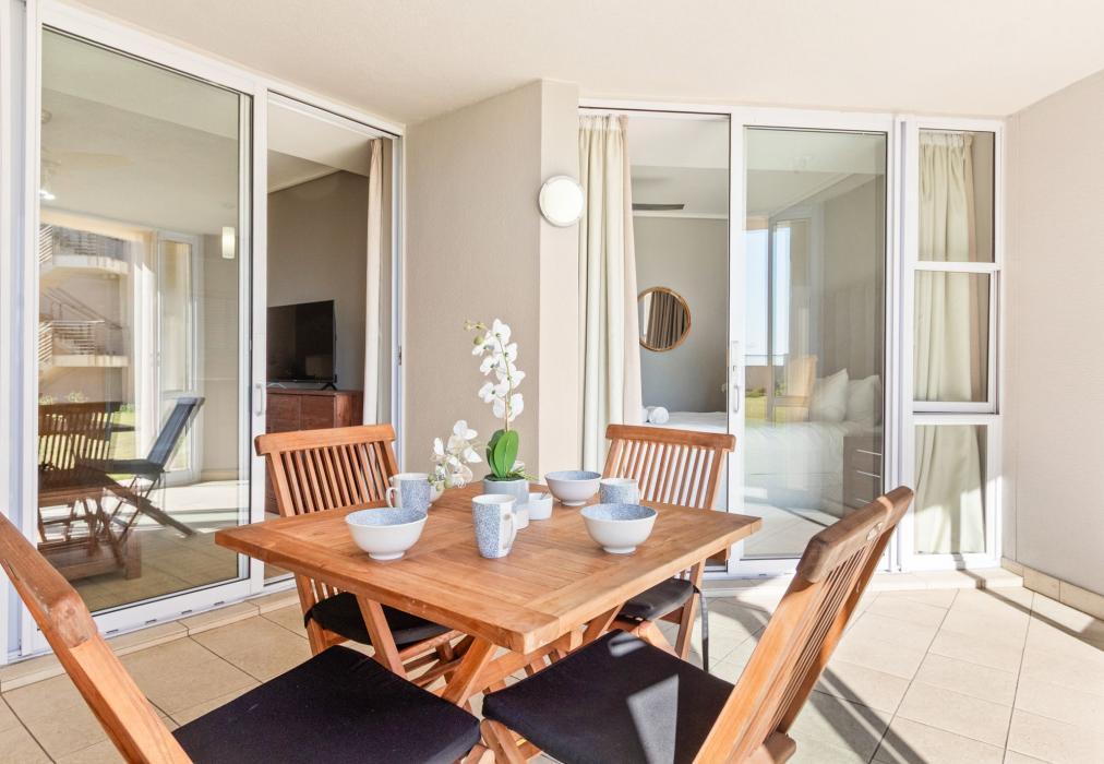 Sunny Covered Patio with Outdoor Dining at Lagoon Beach 29A