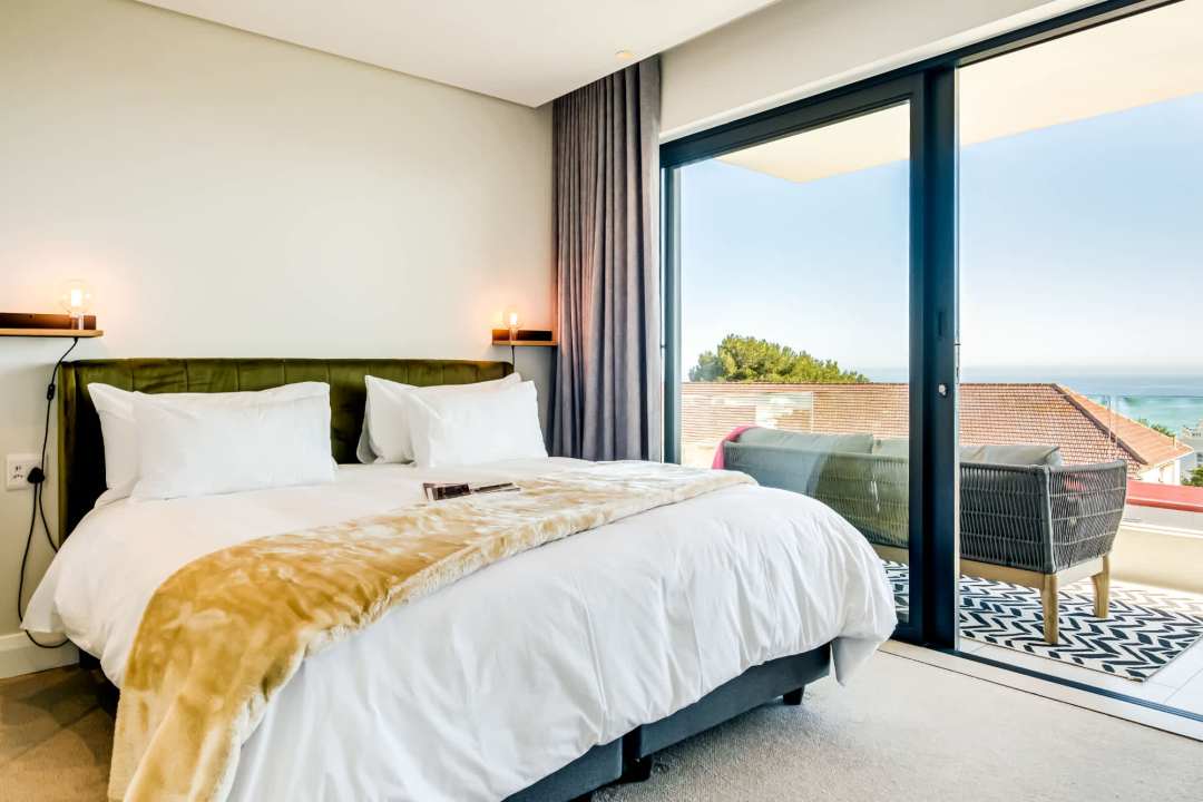 Luxurious sea-view bedroom with balcony access at Marula One