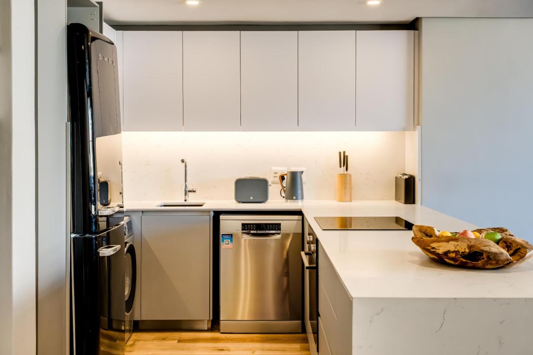 Sleek modern kitchen with integrated appliances at Bantry Suite