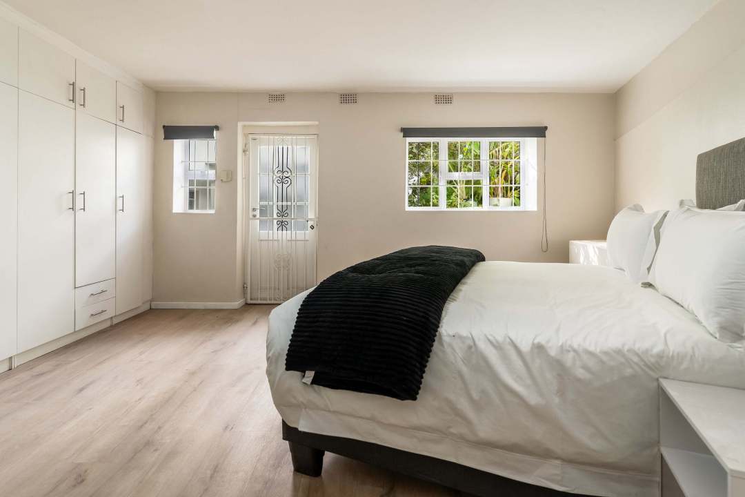 Spacious bedroom with built-in cupboards and private entry at Caprice Bay