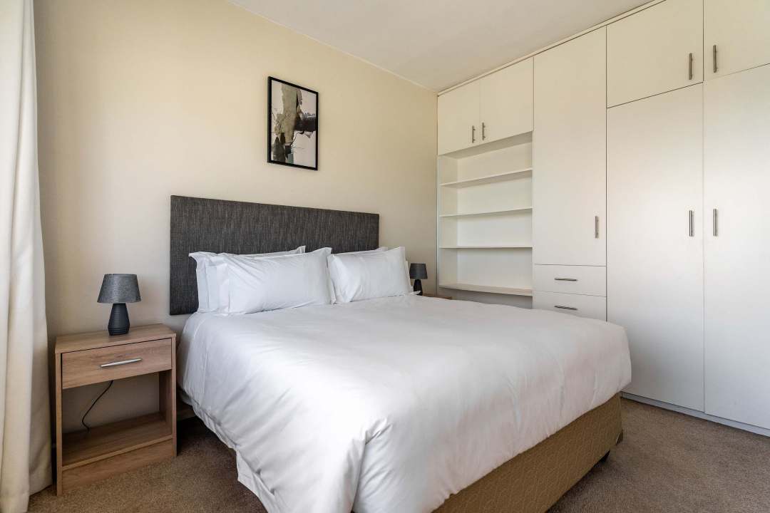 Cozy bedroom with built-in storage and soft neutral tones at Caprice Bay