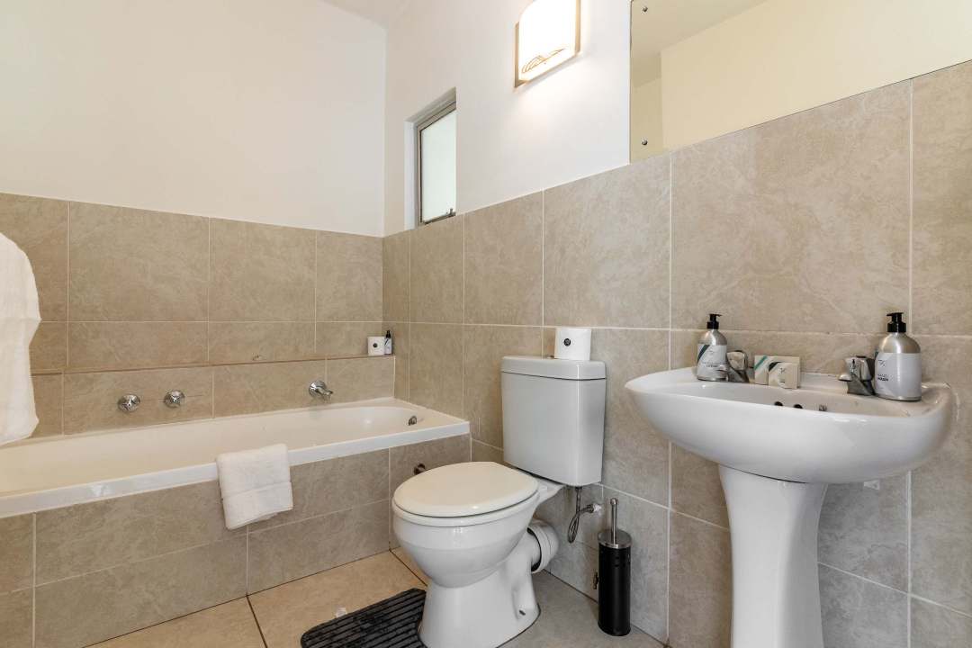 Simple and functional bathroom with bathtub at Caprice Bay