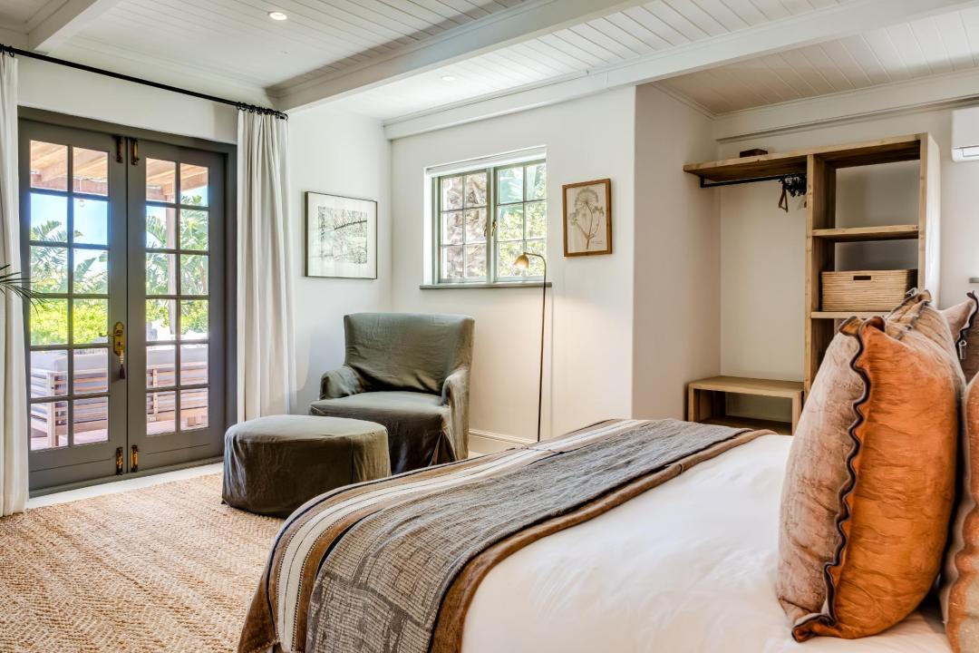 Warm and inviting bedroom with private balcony access at Solmara