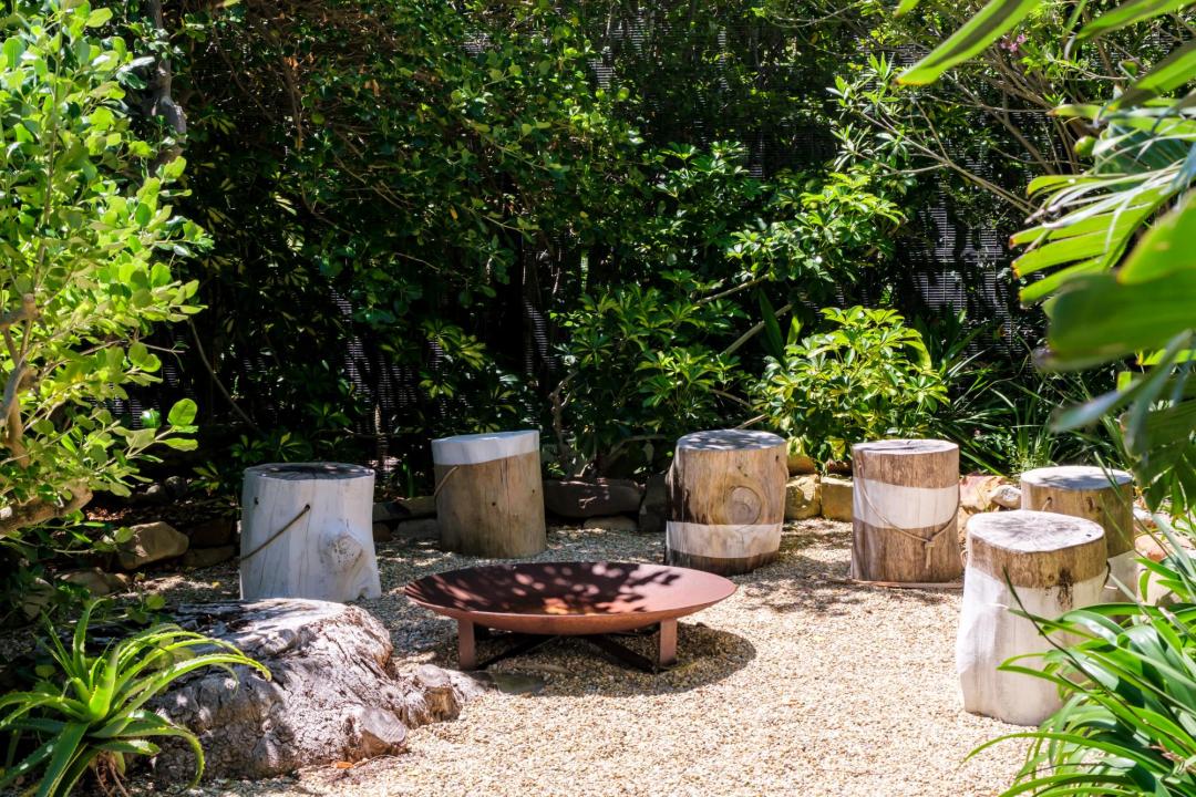 Secluded garden firepit area surrounded by greenery at Solmara