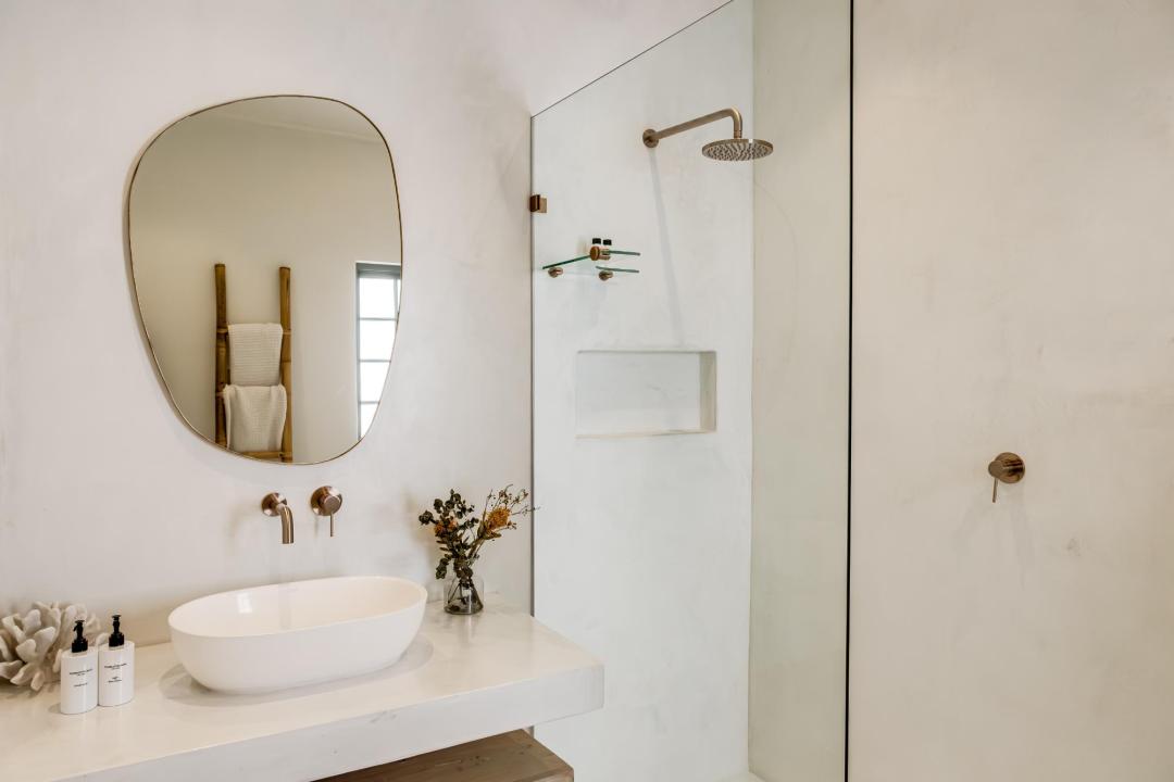 Elegant minimalist bathroom with walk-in shower at Solmara