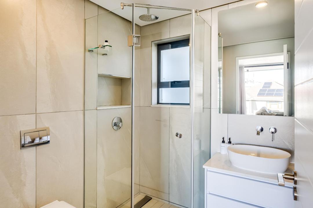 Contemporary glass-enclosed bathroom with sleek finishes at Bantry Pad