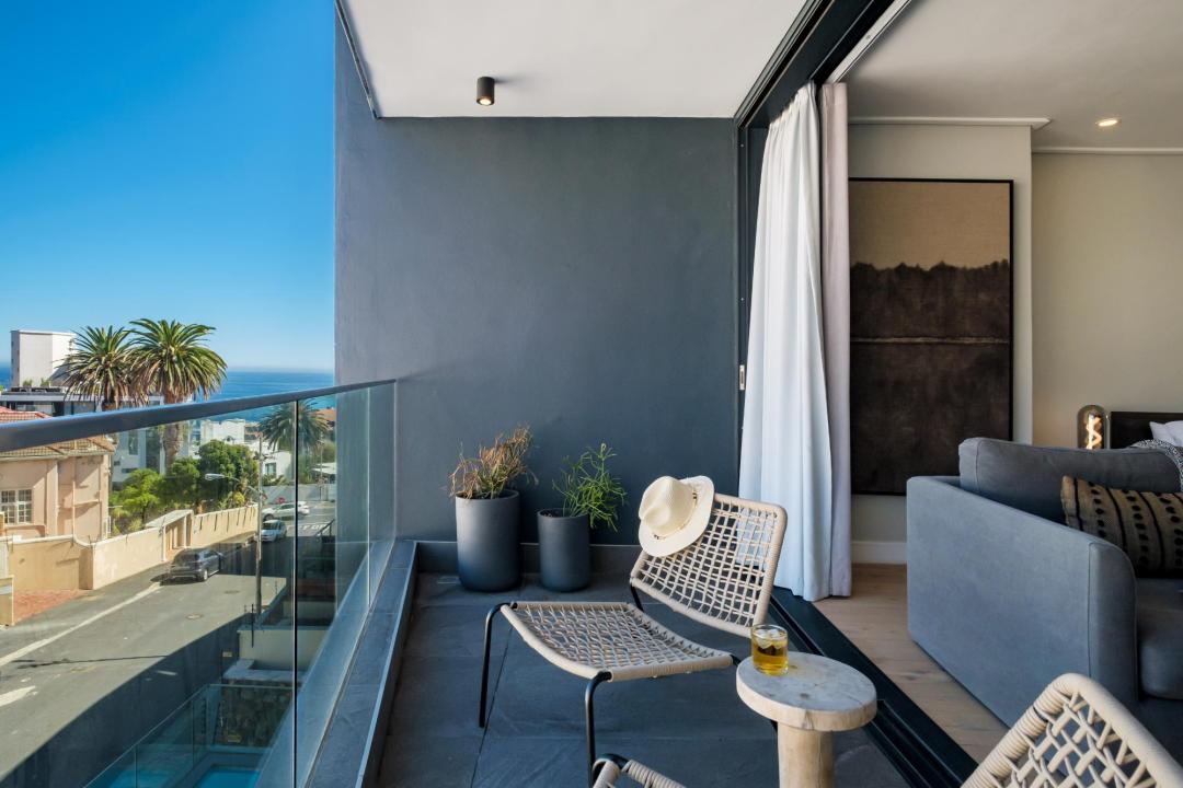 Stylish balcony with ocean glimpse and contemporary seating at Bantry Pad