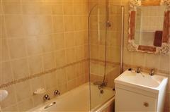 Warm Tiled Bathroom with Shower-Bath Combo at KiteSky Langebaan