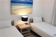 Bright Twin Bedroom with Coastal Artwork at KiteSky Langebaan