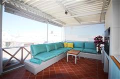 Covered Outdoor Lounge with Lagoon Views and Turquoise Seating at KiteSky Langebaan