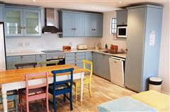 Charming Open-Plan Kitchen with Colourful Dining Space at KiteSky Langebaan