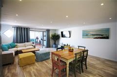 Spacious Open-Plan Living and Dining Area with Lagoon-Inspired Décor at KiteSky Langebaan