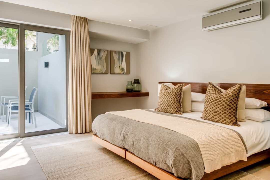 Tranquil en-suite bedroom with private patio access at Blue Ocean Penthouse