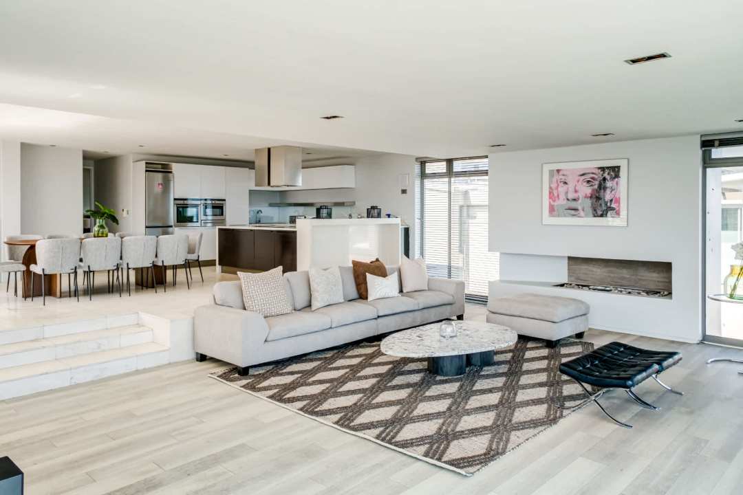 Stylish open-plan living area with modern fireplace at Blue Ocean Penthouse