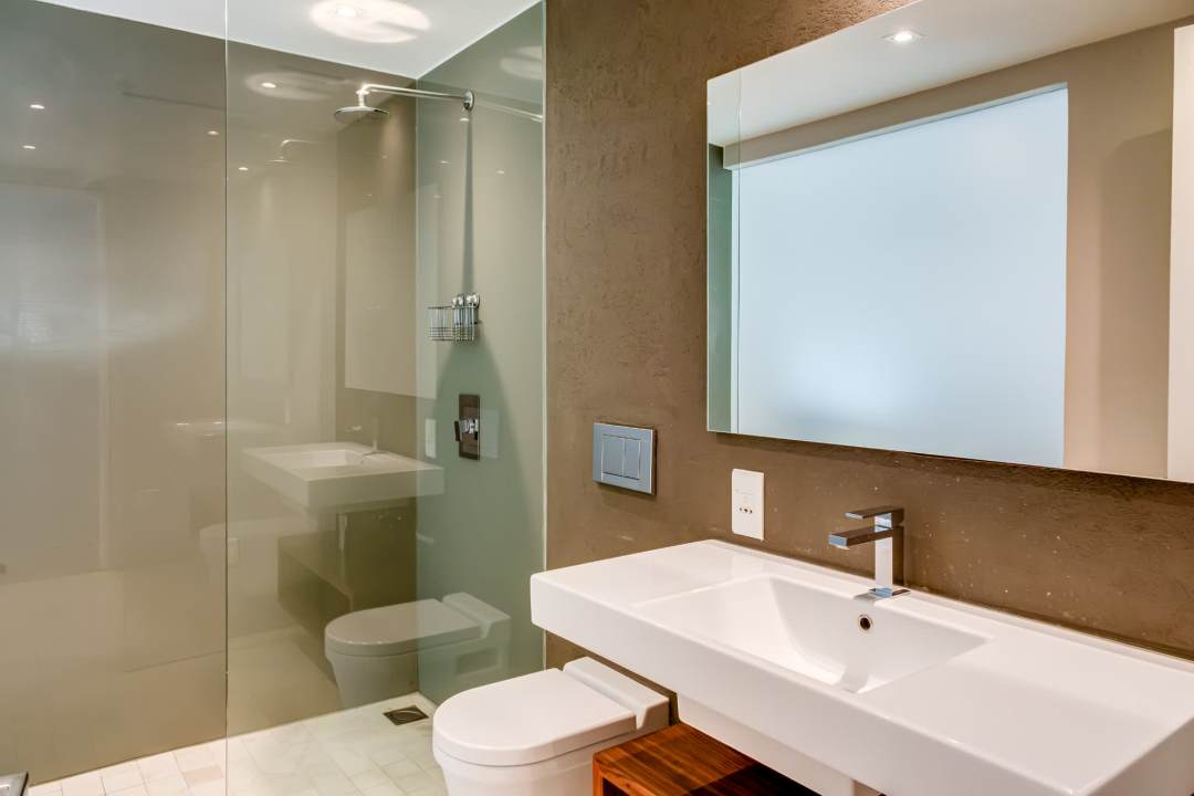 Modern walk-in shower and sleek vanity design at Blue Ocean Penthouse