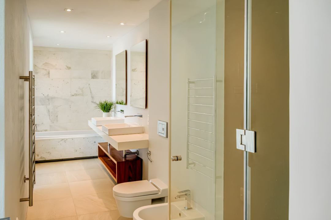 Luxurious en-suite bathroom with double vanity and soaking tub at Blue Ocean Penthouse